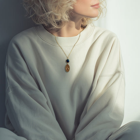 Gold snake pendant necklace with emerald gemstone, symbolizing transformation and elegance, perfect for statement jewelry lovers.