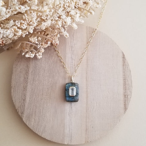Dainty Labradorite pendant necklace featuring a shimmering Labradorite gemstone accented with an inlaid White Topaz stone, hanging from a delicate gold chain. Elegant and meaningful, this handmade necklace symbolizes clarity, intuition, and light,a perfect gift for her.