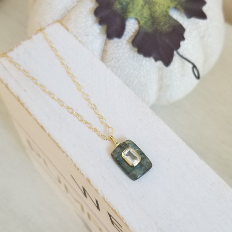 Dainty Labradorite pendant necklace featuring a shimmering Labradorite gemstone accented with an inlaid White Topaz stone, hanging from a delicate gold chain. Elegant and meaningful, this handmade necklace symbolizes clarity, intuition, and light,a perfect gift for her.