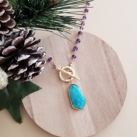 Beaded amethyst necklace featuring a turquoise pendant and front toggle clasp, handcrafted boho chic jewelry with a touch of charm and elegance.