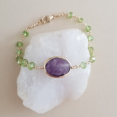 Handmade bracelet with faceted peridot and amethyst beads, vibrant green and purple gemstones, boho-chic jewelry perfect for gifting or everyday wear.