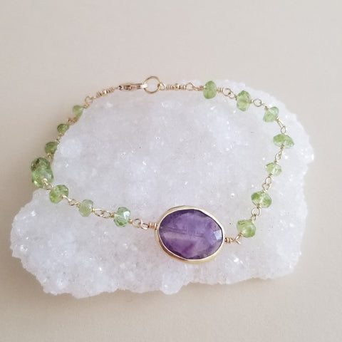 Handmade bracelet with faceted peridot and amethyst beads, vibrant green and purple gemstones, boho-chic jewelry perfect for gifting or everyday wear.