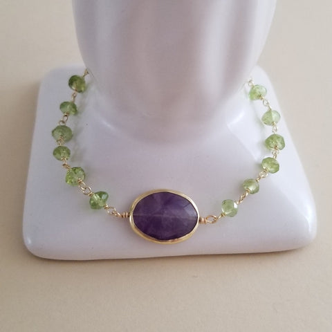 Handmade bracelet with faceted peridot and amethyst beads, vibrant green and purple gemstones, boho-chic jewelry perfect for gifting or everyday wear.