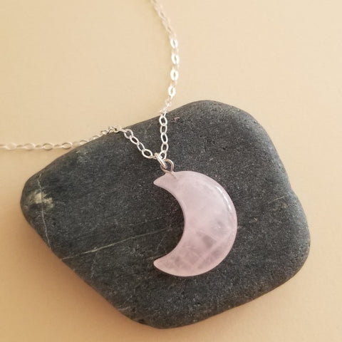 A delicate Rose Quartz Crescent Moon pendant necklace on a dainty gold chain, featuring soft pink tones and a feminine boho style — perfect for everyday wear or as a romantic gift.