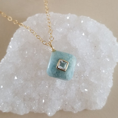 Delicate aquamarine pendant with white topaz inlay on a thin gold chain, dainty March birthstone necklace for women.