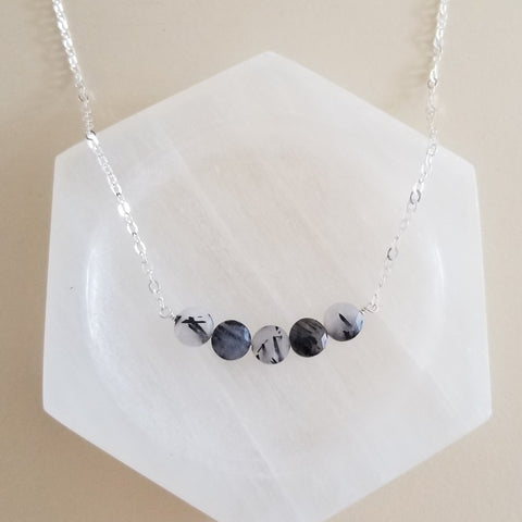 Minimalist necklace with a row of faceted black rutilated quartz stones on a dainty chain, elegant handmade crystal jewelry.