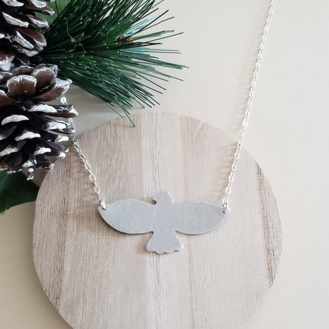 Hand-hammered bird pendant necklace featuring a soaring bird design on a dainty sterling silver chain.. Symbolic of freedom and grace, this handmade necklace makes a meaningful gift for her or a beautiful everyday accessory.