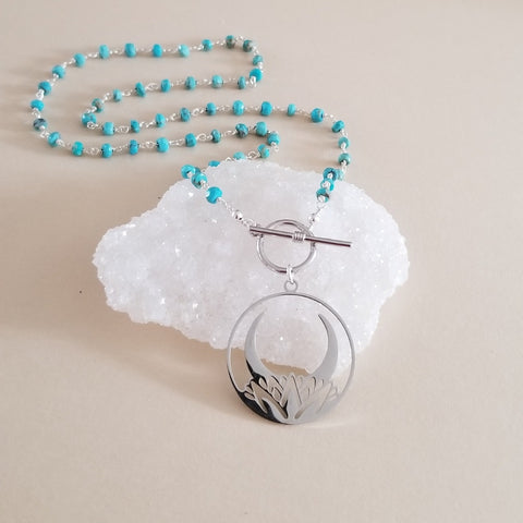 Handmade beaded turquoise necklace with a lotus moon pendant. Modern front toggle necklace. Jewelry gift for her