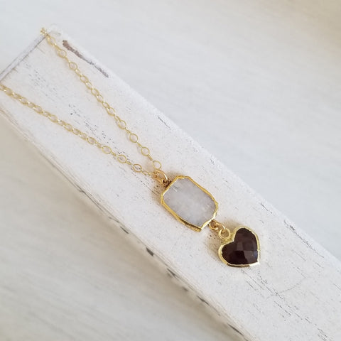 Handmade moonstone and garnet heart pendant necklace displayed on a gold filled chain. Boho gemstone necklace