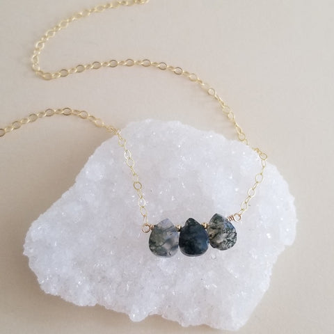 Delicate necklace featuring three small Moss Agate teardrop gemstones on a sterling silver or gold-filled chain, dainty crystal jewelry with natural green stone patterns.