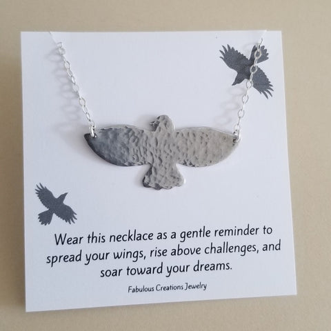 Hand-hammered bird pendant necklace featuring a soaring bird design on a dainty sterling silver chain.. Symbolic of freedom and grace, this handmade necklace makes a meaningful gift for her or a beautiful everyday accessory.